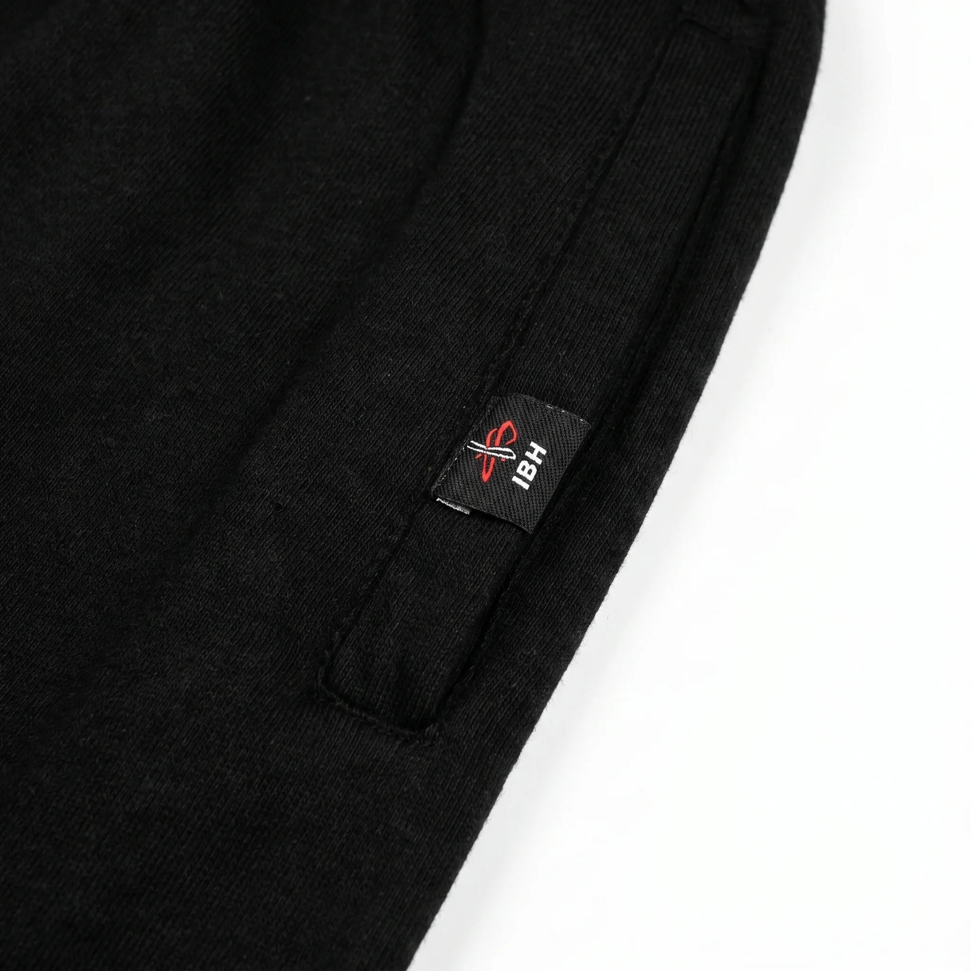 Black trouser with a visible brand label on a white background